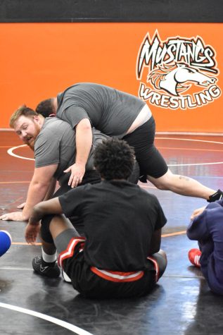 Foothill High coaches teach wrestlers new holds and escapes.