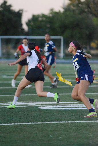 Nia Ryan, Inderkum sophomore, pulls a flag during a headed game against Bella Vista High. 