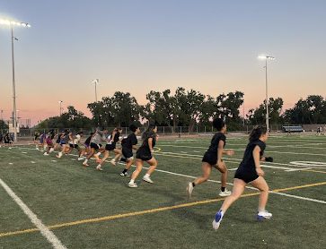 New flag football athletes from Franklin High School sprint at the end of practice.