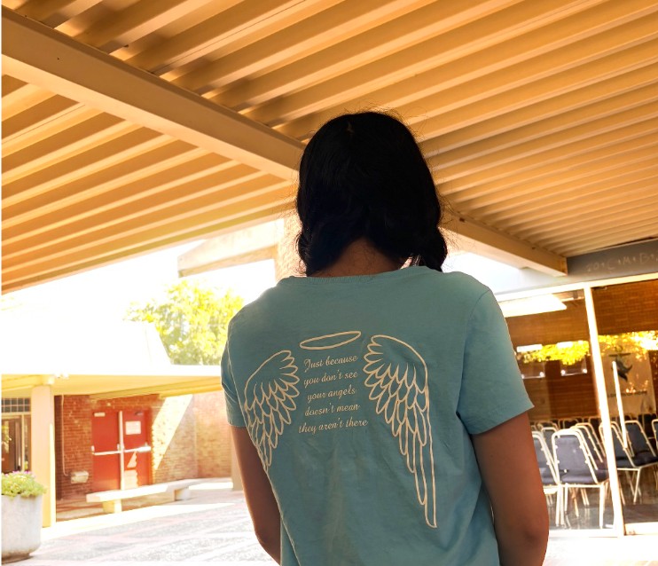Members of the St. Francis Guardian Angel Peer Team wear a baby blue shirt. The motto reads: “Just because you don’t see your angels doesn’t mean they aren’t there.”