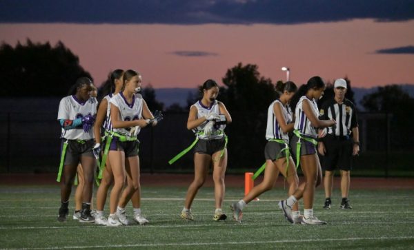 The Franklin High girls' flag football team heads to the line of scrimmage after calling a play in a recent game.